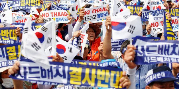 Seoungju residents chant slogans during a protest against the government's decision on deploying a U.S. THAAD anti-missile defense unit in Seongju, in Seoul, South Korea, July 21, 2016. The banner reads