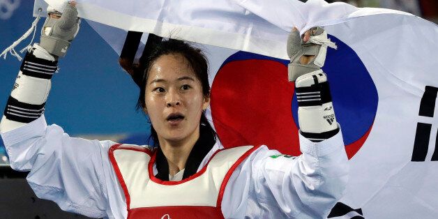 Oh Hyeri of South Korea celebrates after winning a women's Taekwondo 67-kg final at the 2016 Summer Olympics in Rio de Janeiro, Brazil, Friday, Aug. 19, 2016. (AP Photo/Andrew Medichini)