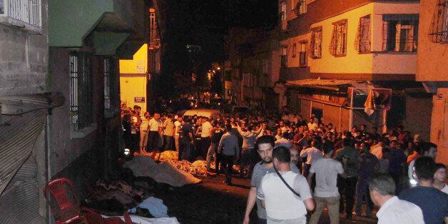 People gather after an explosion in Gaziantep, southeastern Turkey, early Sunday, Aug. 21, 2016. Gaziantep Province Gov. Ali Yerlikaya said the deadly blast, during a wedding near the border with Syria, was a terror attack.