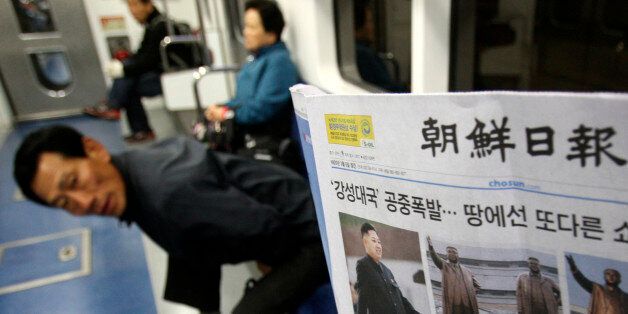 A subway passenger reads a South Korean newspaper Chosun Ilbo reporting North Korea's rocket launch in Seoul, South Korea, Saturday, April 14, 2012.  North Korea's much-touted satellite launch ended in a nearly $1 billion failure, bringing humiliation to the country's new young leader and condemnation from a host of nations. The United Nations Security Council deplored the launch but stopped short of imposing new penalties in response. The headline reads