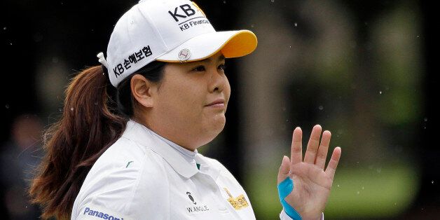 Inbee Park, of South Korea, gives a wave to fans after making a putt during the first round at the Women's PGA Championship golf tournament at Sahalee Country Club on Thursday, June 9, 2016, in Sammamish, Wash. (AP Photo/Elaine Thompson)