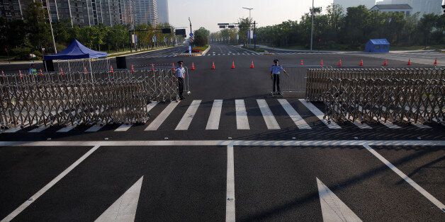 Policemen secure the road near the venue of the G20 Summit in Hangzhou, Zhejiang province, China September 3, 2016.    REUTERS/Damir Sagolj
