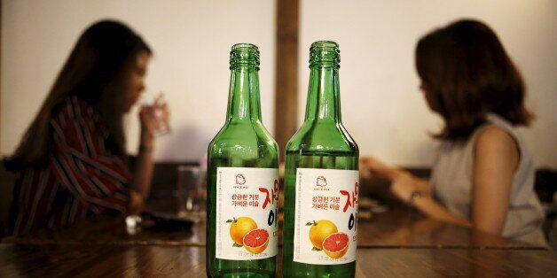 Bottles of fruit flavoured and low-alcohol soju are seen in this picture illustration at a pub in Seoul, South Korea, September 9, 2015. Professional women are driving a change in the way beverage companies look at South Korea, which hard-drinking men have made Asia's biggest alcohol consuming country on a per capita basis. As more women join the workforce in South Korea, a growing share of younger women are becoming regular drinkers, shifting consumption patterns in a male-dominated society where post-work drinking sessions are a staple of office life. Rising incomes and a greater interest in health also mean fewer Koreans merely seek out the cheapest way to get drunk. Picture taken September 9, 2015.  REUTERS/Kim Hong-Ji