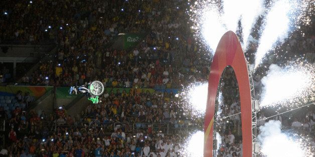 Aaron Wheelz, an extreme wheelchair athlete flies through a panel with the number zero, marking the start of the Opening Ceremony of the Rio 2016 Paralympic Games in Rio de Janeiro, Brazil, Wednesday, Spey. 7, 2016. (Photo Thomas Lovelock/OIS/IOC via AP)