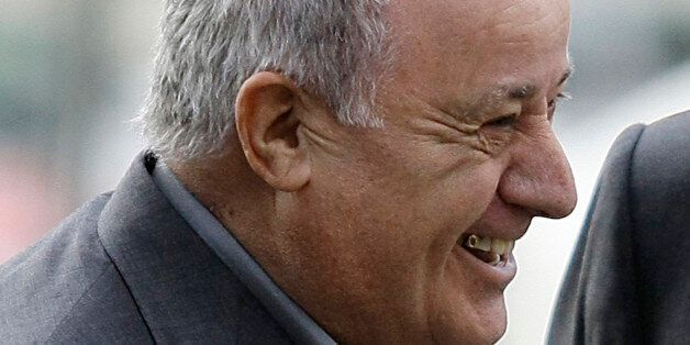 Amancio Ortega, chairman of Spanish global fashion group Inditex, laughs during a visit of Spain's Princess Letizia and Crown Prince Felipe to his factory in Coruna, northern Spain December 2, 2008. REUTERS/Miguel Vidal (SPAIN)