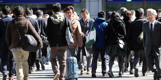 People cross a street in Tokyo, Friday, Feb. 26, 2016. The results of the 2015 census released Friday show the population dropped by 947,000 people in the last five years, the first decline since the count started in 1920. Japan's population stood at 127.1 million last fall, down 0.7 percent from 128.1 million in 2010. (AP Photo/Koji Sasahara)