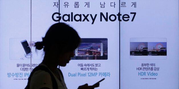 A woman walks by an advertisement of Samsung Electronics Galaxy Note 7 smartphone at the company's showroom in Seoul, South Korea, Friday, Sept. 2, 2016. Samsung Electronics recalled all of its Galaxy Note 7 smartphones on Friday after its investigation found batteries of some of the flagship gadgets caused the phone to explode or to catch fire. (AP Photo/Ahn Young-joon)