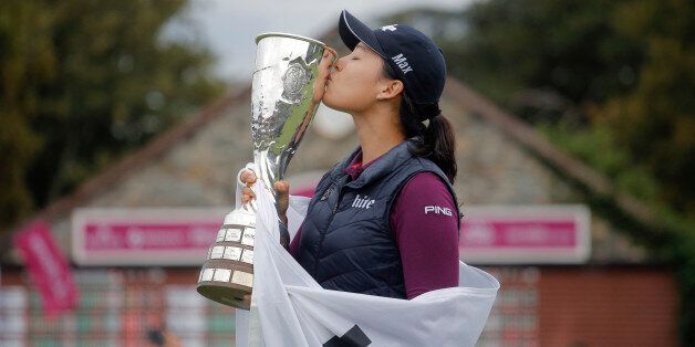 In Gee Chun of South Korea celebrates with her trophy after winning the Evian Championship women's golf tournament in Evian, eastern France, Sunday, Sept. 18, 2016. (AP Photo/Laurent Cipriani)