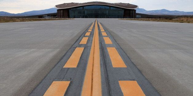 FILE - This Dec. 9, 2014, file photo shows the taxiway leading to the hangar at Spaceport America in Upham, N.M. New Mexico Spaceport Authority director Christine Anderson, who is resigning, said the spaceport is on the right track and she believes it will be a game changer for New Mexico. (AP Photo/Susan Montoya Bryan)