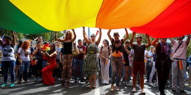 Participants hold a rainbow flag during an annual LGBT (Lesbian, Gay, Bisexual and Transgender) pride parade in Belgrade, Serbia September 18, 2016.  REUTERS/Marko Djurica