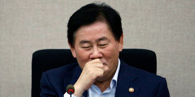 South Korea's Finance Minister Choi Kyung-hwan reacts during a meeting with the managing committee of public institutions at the Government Complex in Seoul July 31, 2014. Three turbocharged weeks into his new job, Choi has impressed markets so much that they already talk of
