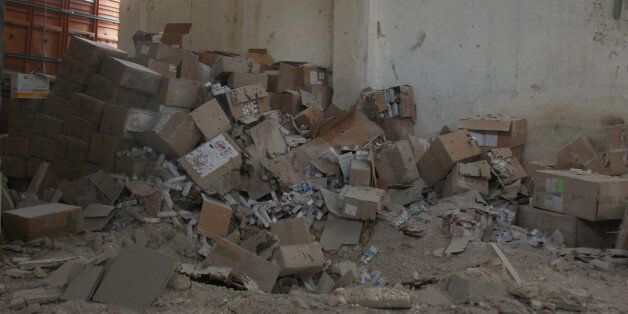 Damaged Red Cross and Red Crescent medical supplies lie inside a warehouse after an airstrike on the rebel held Urm al-Kubra town, western Aleppo city, Syria September 20, 2016. REUTERS/Ammar Abdullah