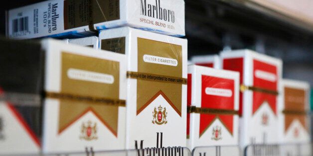 Packs of Marlboro cigarettes are displayed for sale at a convenience store in Somerville, Massachusetts July 17, 2014.  Cigarette maker Philip Morris International Inc cut its earnings forecast for 2014 and said it is proving to be a