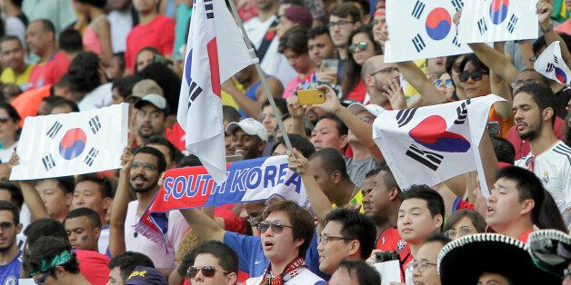 Fans of South Korea cheer before the group C match of the men's Olympic football tournament between Germany and South Korea at the Fonte Nova Arena in Salvador, Brazil, Sunday, Aug. 7, 2016. (AP Photo/Arisson Marinho)