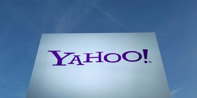 A Yahoo logo is pictured in front of a building in Rolle, east of Geneva, Switzerland December 12, 2012.   REUTERS/Denis Balibouse/File Photo