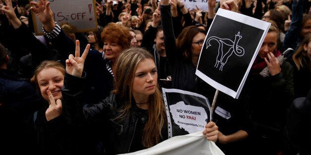 Women gesture as people gather in an abortion rights campaigners' demonstration to protest against plans for a total ban on abortion in front of the ruling party Law and Justice (PiS) headquarters in Warsaw, Poland October 3, 2016. REUTERS/Kacper Pempel TEMPLATE OUT. TPX IMAGES OF THE DAY