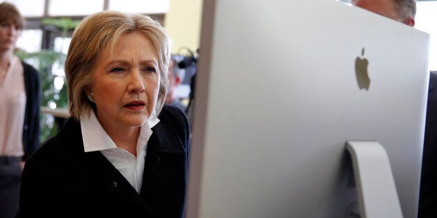 U.S. Democratic presidential candidate Hillary Clinton looks at a computer screen during a campaign stop at Atomic Object company in Grand Rapids, Michigan, March 7, 2016. REUTERS/Carlos Barria
