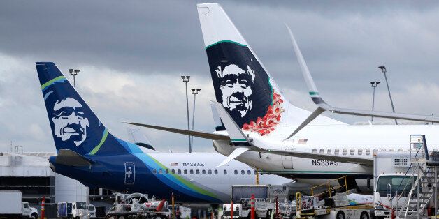 FILE - In this Monday, April 4, 2016, file photo, Alaska Airlines planes with the company's new livery and tail logo, left, and the old livery used to promote service to Hawaii, right, are shown parked at Seattle-Tacoma International Airport in Seattle. Alaska Airlines and JetBlue Airways still rank highest in the annual J.D. Power survey of passengers on the nine largest North American airlines, and the firm says overall traveler satisfaction with the industry is at a 10-year high. J.D. Power s