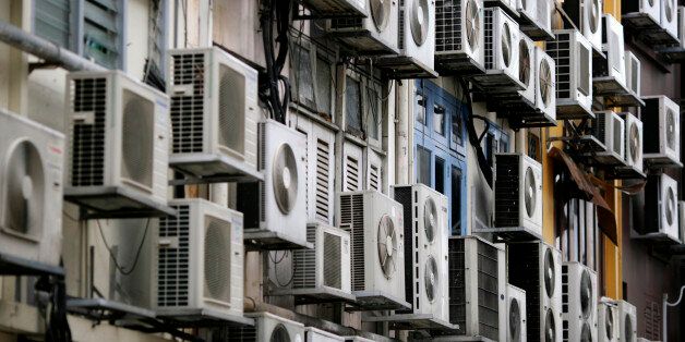 Rows of air conditioners are seen on the walls of a building in Singapore's financial district December 11, 2009.   REUTERS/Vivek Prakash  (SINGAPORE ENVIRONMENT ENERGY POLITICS)