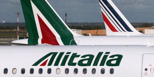 In this photo taken on Nov. 4, 2013 Alitalia, left, and Air France, right, planes are parked on the tarmac at the Fiumicino airport in Rome. The CEO of Etihad Airways says the United Arab Emirates' national airline is looking forward to clinching a proposed deal involving a big stake in struggling Italian carrier Alitalia. The two airlines said in a joint statement that Etihad Airways on Sunday, June 1, 2014 confirmed that it will send a letter detailing conditions for a proposed equity investme