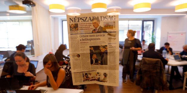 A copy of the last issue of the leftist newspaper Nepszabadsag, which was unexpectedly shut down on Saturday amid cries of a crackdown by right-wing Prime Minister Viktor Orban's government, hangs on the wall of a temporary newsroom in Budapest, Hungary, 10 October, 2016. REUTERS/Laszlo Balogh