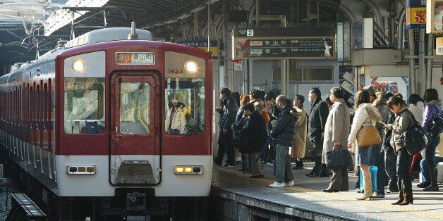 JAPAN - FEBRUARY 05:  Commuters stand on the station platform at Kintetsu Corp.'s Tsuruhashi station in Osaka, Japan, on Tuesday, Feb. 5, 2008. Kintetsu Corp. is a Kansai-based railway operator.  (Photo by Yuzuru Yoshikawa/Bloomberg via Getty Images)