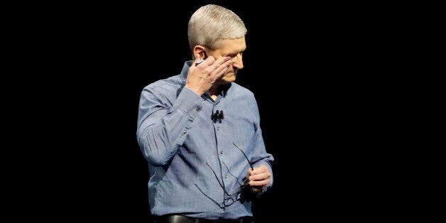 Apple Inc. CEO Tim Cook wipes his eyes after leading a moment of silence for the victims of the attack in Orlando as he opens the company's World Wide Developers Conference in San Francisco, California June 13, 2016.  REUTERS/Stephen Lam