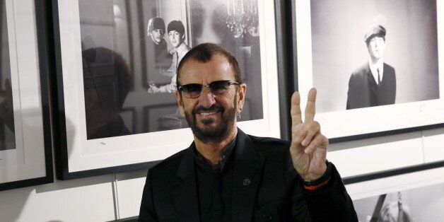 Musician Ringo Starr poses in front of some of his photographs during a media event as he launches his book