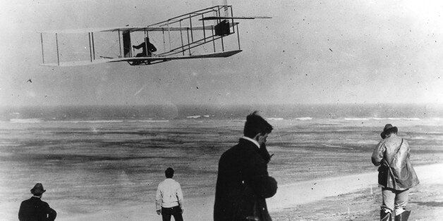 In this undated file photo, Orville and Wilbur Wright test their airplane on a beach. The Wright brothers have long been credited as the first to achieve powered flight. But in June, 2013, Connecticut Gov. Dannel P. Malloy signed a law giving German-born aviator and Connecticut resident Gustave Whitehead the honor of being first. On Thursday, Oct. 23, 1013 Ohio state Rep. Rick Perales and North Carolina state Sen. Bill Cook held news conferences to dispute Connecticut's action and reassert the W