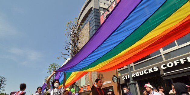 Supporters of the lesbian, gay, bisexual and transgender community (LGBT) carry a rainbow banner as they take part in the 'Tokyo Rainbow Pride' parade in Tokyo on April 27, 2014. Organisors said some 14,000 supporters of the LGBT community, many in costume, marched in Tokyo's Shibuya and Harajuku shopping districts.     AFP PHOTO / Yoshikazu TSUNO        (Photo credit should read YOSHIKAZU TSUNO/AFP/Getty Images)
