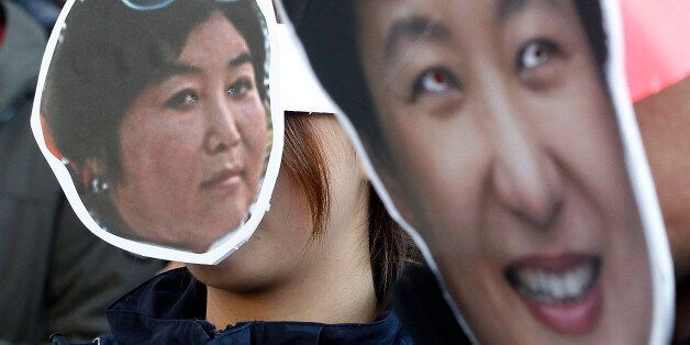 South Korean protesters wearing masks of South Korean President Park Geun-hye, right, and Choi Soon-sil, who is at the center of a political scandal, attend a rally calling for Park to step down in downtown Seoul, South Korea, Wednesday, Nov. 2, 2016. South Korea's embattled president has replaced her prime minister and two other top officials in a bid to restore public confidence amid a political scandal involving her longtime friend. (AP Photo/Ahn Young-joon)