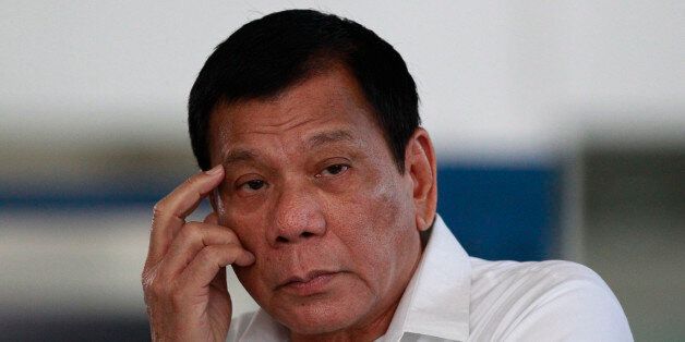 Philippine President Rodrigo Duterte listens to a question from reporters at Manila's International Airport, Philippines on Wednesday, Nov. 9, 2016. Duterte is set to fly to Bangkok to pay his respects to late Thailand's King Bhumibol Adulyadej. He then goes to Malaysia for an official visit. (AP Photo/Aaron Favila)