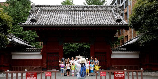 People pose for a photo in front of Akamon Gate at the University of Tokyo in Tokyo, Japan July 20, 2016.  REUTERS/Toru Hanai     AUNIV