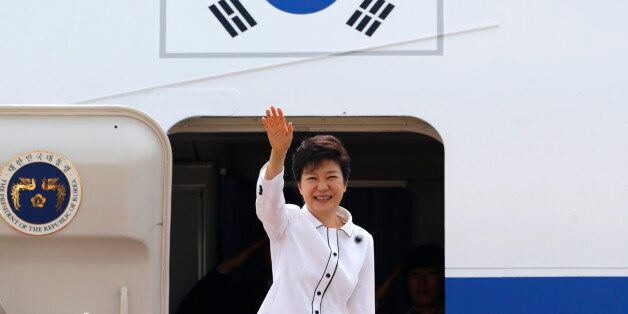 South Korean President Park Geun-hye waves as she embarks an airplane at the Seoul Air Base of South Korean air force in Seongnam, south of Seoul June 27, 2013, before she leaves for China. Park will arrive in Beijing on Thursday for her four-day state visit and will hold her first summit with Chinese President Xi Jinping.   REUTERS/Lee Jae-Won (SOUTH KOREA - Tags: POLITICS)