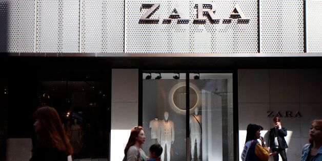 Pedestrians and shoppers walk past a Zara fashion store, operated by Inditex SA, in the Myeongdong shopping district of Seoul, South Korea, on Friday, April 17, 2015. South Korea is scheduled to release gross domestic product (GDP) figures on April 23. Photographer: Woohae Cho/Bloomberg via Getty Images