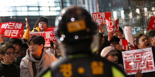 South Korean protesters march toward the presidential house during a rally calling for South Korean President Park Geun-hye to step down in Seoul, South Korea, Saturday, Nov. 19, 2016. For the fourth straight weekend, masses of South Koreans were expected to descend on major avenues in downtown Seoul demanding an end to the presidency of Park, who prosecutors plan to question soon over an explosive political scandal. The banners read: