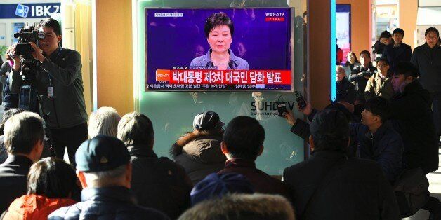 People watch a television news live showing South Korean President Park Geun-Hye making a speech, at a railway station in Seoul on November 29, 2016.South Korea's scandal-hit President Park Geun-Hye said on November 29 she was willing to leave office before the end of her official term early 2018 and would let parliament decide on her fate. / AFP / JUNG Yeon-Je        (Photo credit should read JUNG YEON-JE/AFP/Getty Images)