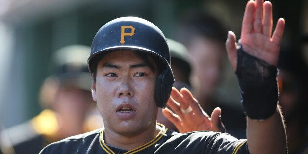 May 23, 2015; Pittsburgh, PA, USA;  Pittsburgh Pirates shortstop Jung Ho Kang (27) celebrates in the dugout after scoring a run against the New York Mets during the fourth inning at PNC Park. Mandatory Credit: Charles LeClaire-USA TODAY Sports