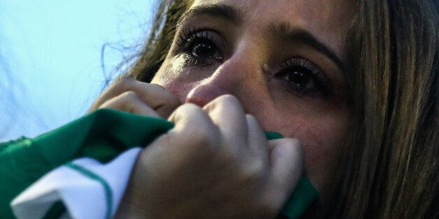 CHAPECO, BRAZIL - NOVEMBER 30:  A fan cries while paying tribute to the players of Brazilian team Chapecoense Real at the club's Arena Conda stadium in Chapeco, in the southern Brazilian state of Santa Catarina, on November 30, 2016. The players were killed in a plane accident in the Colombian mountains. Players of the Chapecoense team were among the 77 people on board the doomed flight that crashed into mountains in northwestern Colombia. Officials said just six people were thought to have surv
