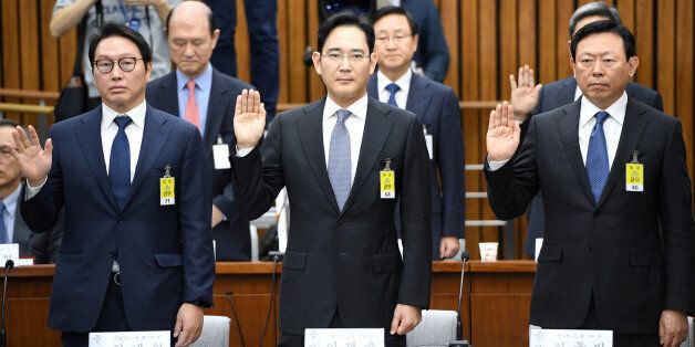 (L-R) SK Group chairman Chey Tae-Won, Samsung Group's heir-apparent Lee Jae-yong and Lotte Group Chairman Shin Dong-Bin take an oath during a parliamentary probe into a scandal engulfing President Park Geun-Hye at the National Assembly in Seoul on December 6, 2016. The publicity-shy heads of South Korea's largest conglomerates faced their worst nightmare on December 6, as they were publicly grilled about possible corrupt practises before an audience of millions. REUTERS/Jung Yeon-Je/Pool