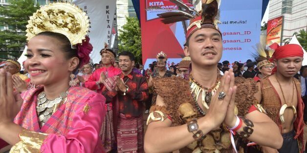 Indonesian dancers perform on a stage during a pro-government rally to call for unity in Jakarta on December 4, 2016. Thousands of people paraded in Indonesia's capital Jakarta on December 4, to call for unity and peace amid growing tensions in the society. / AFP / ADEK BERRY        (Photo credit should read ADEK BERRY/AFP/Getty Images)
