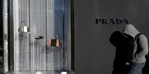 A man walks past a Prada store in Madrid, Spain, March 10, 2016. REUTERS/Susana Vera