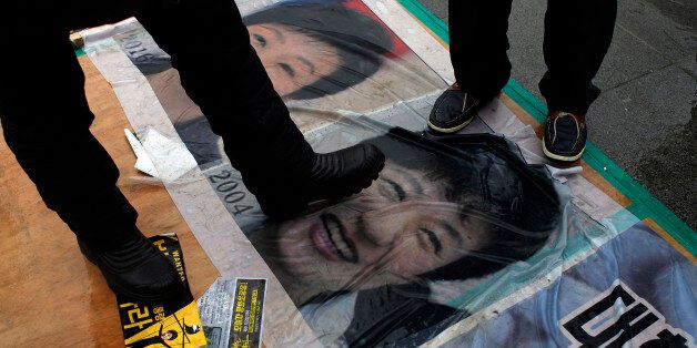 SEOUL, SOUTH KOREA - NOVEMBER 26:  People gathered for a rally against South Korean President Park Geun-hye and step on the Park Geun-hye's portraits on November 26, 2016 in Seoul, South Korea. Park has recorded worst ever polling figures for the country's presidency after her friend Choi Soon-sil was charged with corrupt influence over state affairs.  (Photo by Woohae Cho/Getty Images)