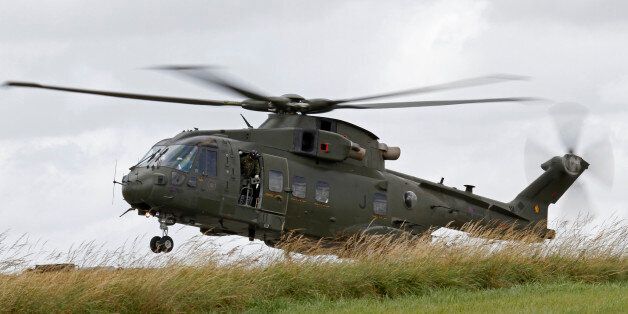 An AW101 Merlin helicopter of the Royal Air Force landing in the field during an exercise in the United Kingdom.