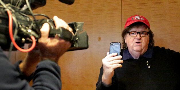 NEW YORK, NY - NOVEMBER 12: Filmmaker Michael Moore films himself with a smartphone at Trump Tower on November 12, 2016 in New York City. President-elect Donald Trump is holding meetings at his Trump Tower residence amid increased security in the area.  (Photo by Yana Paskova/Getty Images)