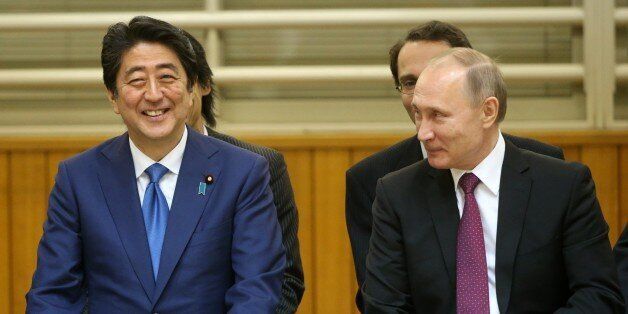 TOKYO, JAPAN - DECEMBER 15: (RUSSIA OUT) Russian President Vladimir Putin (R) and Japanese Prime Minister Shinzo Abe (L) are seen visiting the Kodokan Judo Institute on December 16, 2016  in Tokyo, Japan. Russian President is on a two-day visit to Japan. (Photo by Mikhail Svetlov/Getty Images)