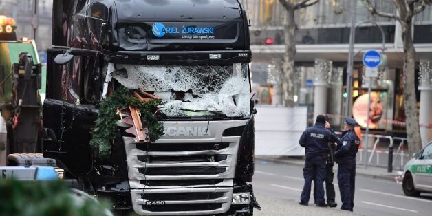 Policemen stand next to a truck on December 20, 2016 at the scene where it crashed into a Christmas market near the Kaiser-Wilhelm-Gedaechtniskirche (Kaiser Wilhelm Memorial Church) in Berlin.German police said they were treating as 'a probable terrorist attack' the killing of 12 people when the speeding lorry cut a bloody swath through the packed Berlin Christmas market. / AFP / Tobias SCHWARZ        (Photo credit should read TOBIAS SCHWARZ/AFP/Getty Images)
