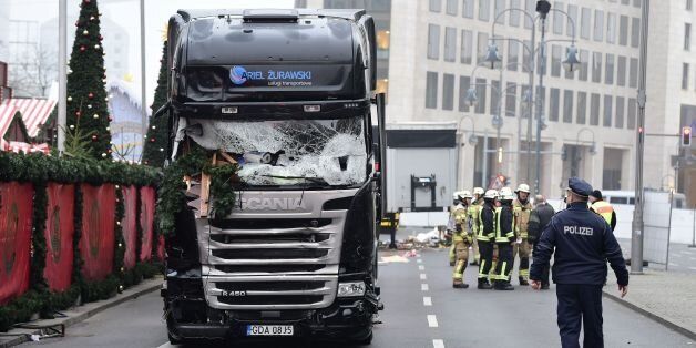 A policeman walks past a truck that crashed into a Christmas market on December 20, 2016 in Berlin.German police said they were treating as 'a probable terrorist attack' the killing of 12 people when the speeding lorry cut a bloody swath through the packed Berlin Christmas market. / AFP / Tobias SCHWARZ        (Photo credit should read TOBIAS SCHWARZ/AFP/Getty Images)