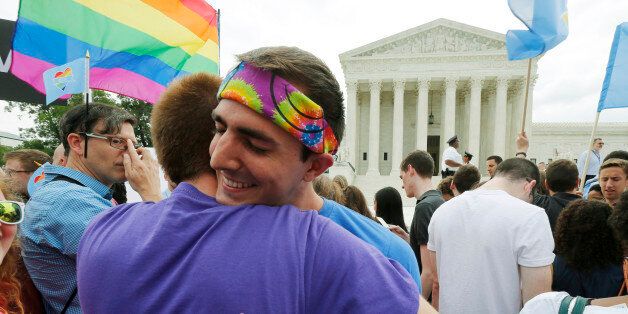 Gay rights supporters celebrate after the U.S. Supreme Court ruled that the U.S. Constitution provides same-sex couples the right to marry, outside the Supreme Court building in Washington, June 26, 2015. The court ruled 5-4 that the Constitution's guarantees of due process and equal protection under the law mean that states cannot ban same-sex marriages. REUTERS/Jim Bourg