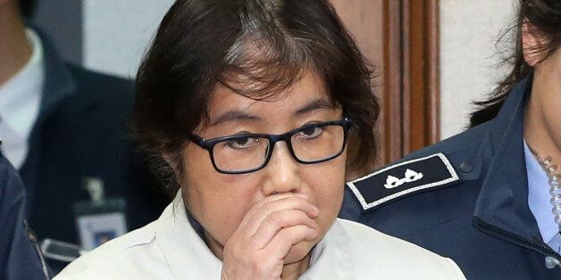 Choi Soon-Sil (C), who has been dubbed Korea's 'female Rasputin' for the influence she wielded over the now-impeached president Park Geun-Hye, arrives at a courtroom for her trial at the Seoul Central District Court in Seoul on December 19, 2016.The woman at the centre of a corruption scandal that triggered the biggest political crisis for a generation in South Korea appeared in court on December 19 for a preliminary hearing in her trial on fraud charges. / AFP / KOREA POOL / KOREA POOL / South Korea OUT        (Photo credit should read KOREA POOL/AFP/Getty Images)